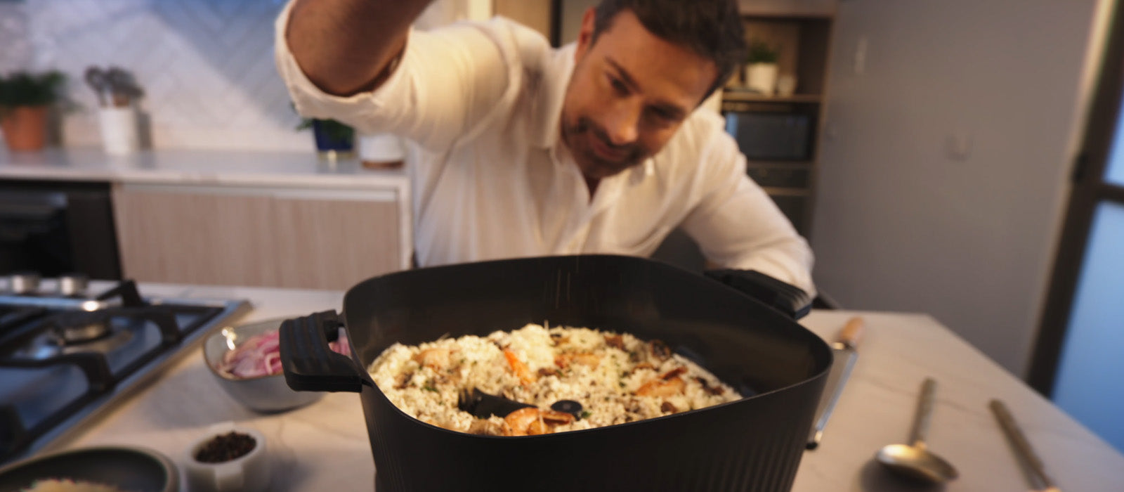 Man cooking in a kitchen with a large pot on the stove