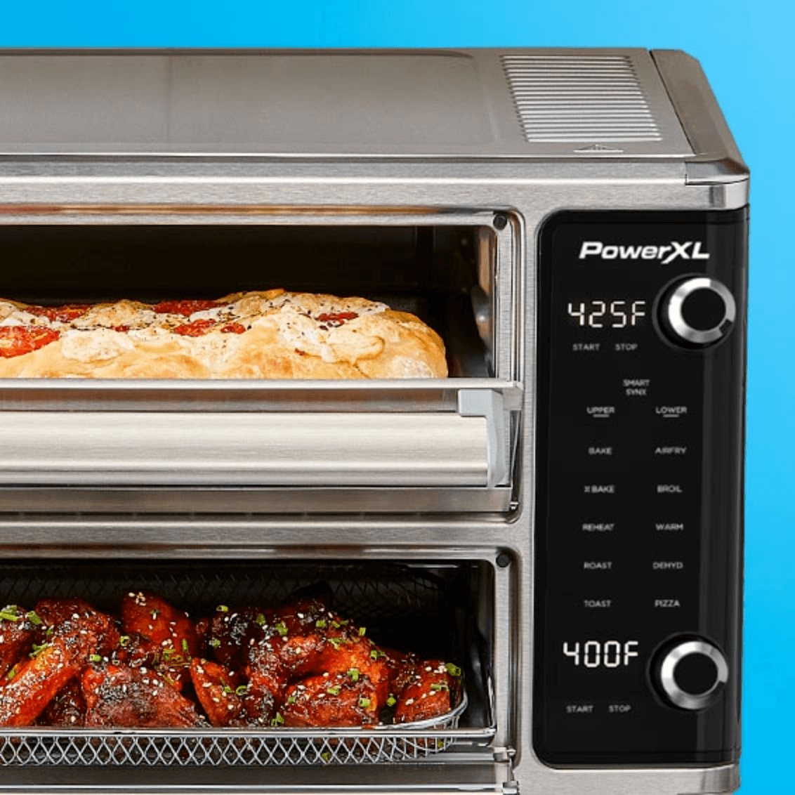 PowerXL toaster oven with pizzas inside on a blue background