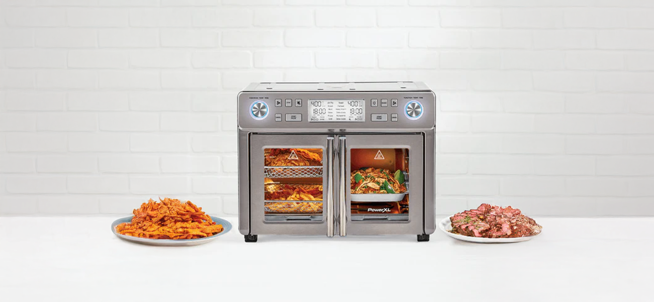 SMart Synx Duplex oven with food items on plates on a white background