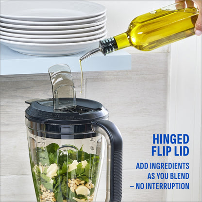 Olive oil being poured through the hinged flip lid