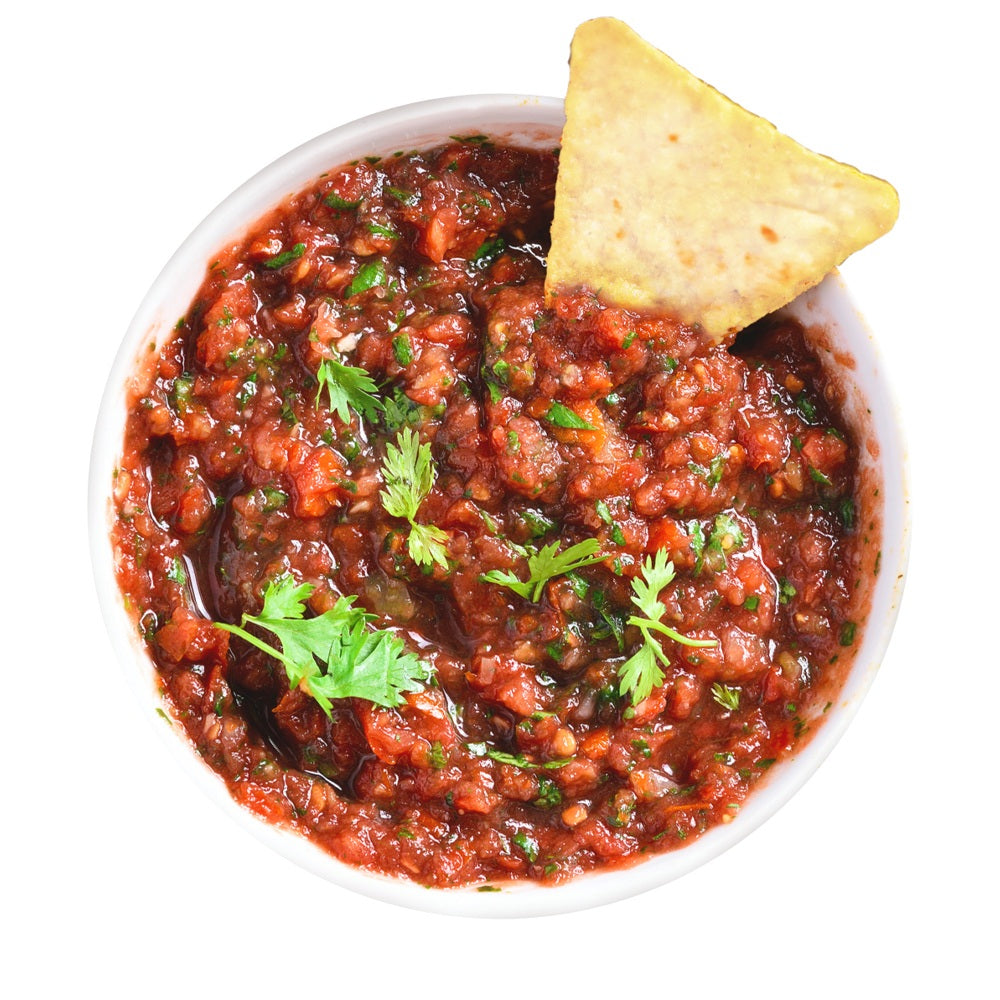 Bowl of salsa with a tortilla chip on a white background