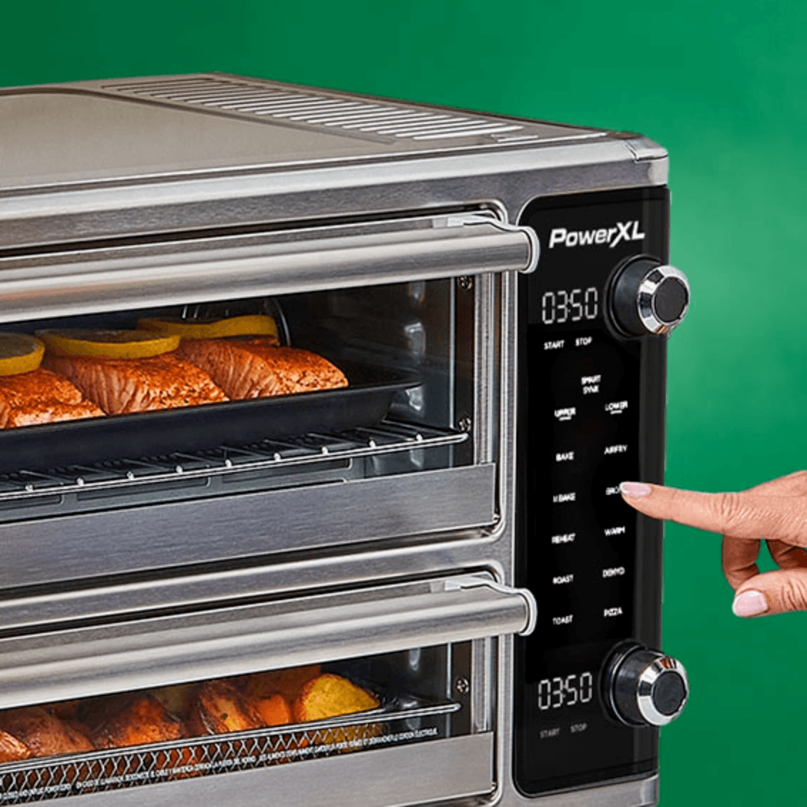 PowerXL toaster oven with food inside on a green background