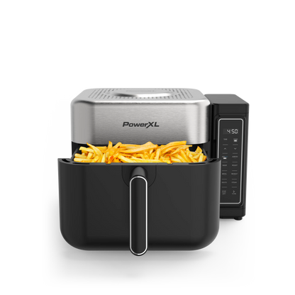 PowerXL air fryer with a basket containing food on a white background